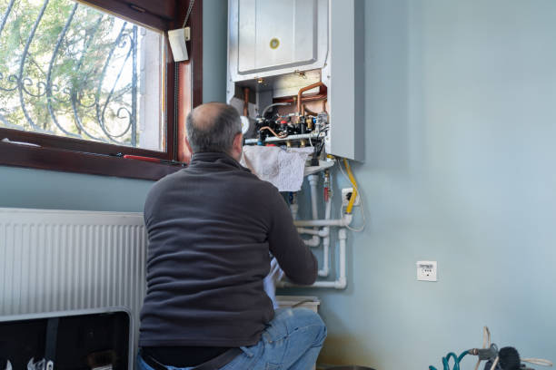 technician repairing natural gas combi boiler at home